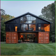 a house made out of shipping containers in the middle of a grassy area with trees and grass