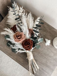 a bouquet of flowers sitting on top of a wooden table