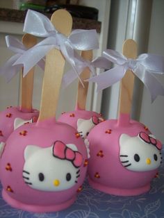 hello kitty cake pops are sitting on a table