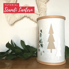 a white canister sitting on top of a wooden shelf next to a green plant