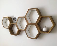 three hexagonal shelves are hanging on the wall