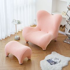 a pink chair and ottoman in a room