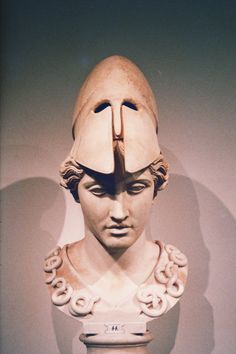 a bust of a man wearing a helmet with donuts on it's head