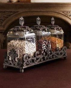 three glass containers filled with food on top of a table