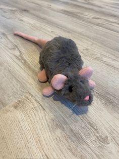 a stuffed mouse is sitting on the floor