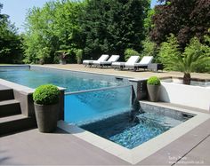 an outdoor swimming pool with steps leading up to it and lounge chairs on the side