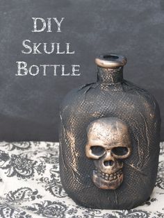 a skull shaped bottle sitting on top of a table next to a black sign that says diy skull bottle