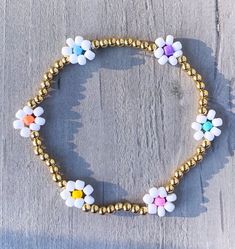 Flower Beaded Bracelet - multi color with 3mm 18k gold filled beads ✨✨ Bracelet comes as shown, if you would like another color please add in Personalization Section* CARING TIPS FOR YOUR JEWELRY ⭐️Treat and store with care. ⭐️ For longevity, avoid exposing your jewelry to water. ⭐️ Avoid having direct contact with lotions, perfumes, sanitizers as these chemicals may cause discoloration of your jewelry. White Beaded Bracelets With Flower Charm For Spring, Spring White Beaded Bracelets With Flower Charm, White Flower-shaped Bracelet With Tiny Beads, Multicolor Flower-shaped Jewelry With Letter Beads, Spring Beaded Bracelets With Flower Shape And Tiny Beads, Spring Beaded Bracelets With Tiny Flower Beads, Spring Flower Beaded Bracelets With Tiny Beads, Spring Flower Bracelets With Colorful Beads, Spring Flower-shaped Bracelets With Colorful Beads