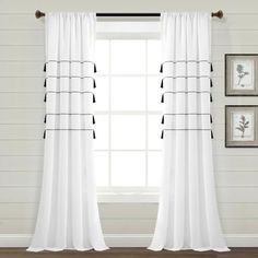 white curtains with black piping on them in front of a window