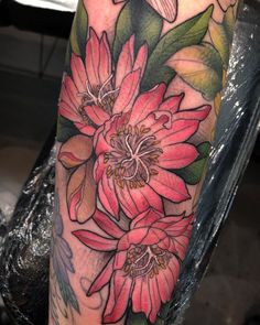 a woman's leg with flowers on it