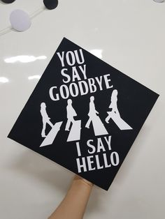 someone is holding up a graduation cap that says you say goodbye