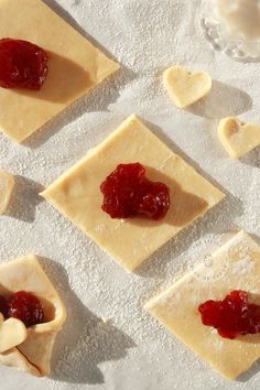 some food that is laying out on the sand and has jelly in between it's corners