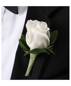 a white rose boutonniere on a black jacket