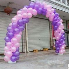 a purple and pink balloon arch with the words ebay $ 4 99 on it