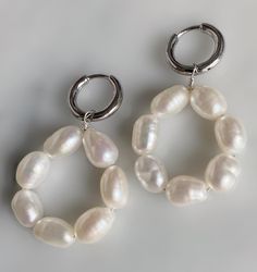 The dreamiest pearl hoops Details: Freshwater white baroque pearls Hoops are .925 sterling silver click hoops Sold as a pair Limited quantities Handmade in Los Angeles Measurements: Drop is approx. 1 inch from hoop Hoop is 12 mm Every item is made to order just for you. Please allow 5-10 business days for production time plus the time for shipping. Thank you and we can't wait to make your unique Drowning Bear piece! If you have any questions, please contact us : info@drowningbear.comSay hello to Everyday Silver Hoop Earrings With Pearl Charm, Baroque Pearl Charm Hoop Earrings, White Hoop Pearl Chain Jewelry, Small Hoop Pearl Earrings, Silver Small Hoop Pearl Earrings, Small Silver Hoop Earrings With Pearl Charm, Silver Small Hoop Earrings With Pearl Charm, Small Hoop Sterling Silver Earrings With Pearl Charm, Silver Small Hoop Pearl Earrings For Everyday