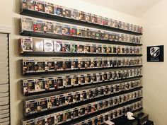 there is a wall full of movies on the shelves