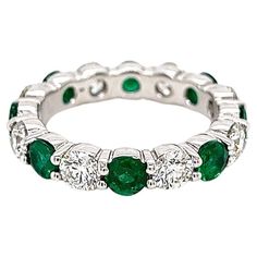 3.36 Total Carat Green Emerald and Diamond Ladies Ring Highly Polished 1.86 Carat Diamond Eternity Band with Green Emerald Gemstone Carat Weight of 1.50 CT. Specifications: -Metal Type: 18K White Gold -1.50 Carat Round Cut Columbian Green Emerald -1.86 Carat Round Natural Diamonds, G-H Color, VS2-SI Clarity -Size 6.25 Proudly made in New York City. Eternity Band Diamond, Diamond Eternity, Emerald Gemstone, Emerald Diamond, Eternity Bands, Ring Verlobung, Pandora Charm Bracelet, Emerald Green, Types Of Metal