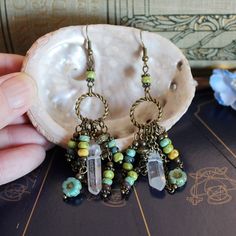 Australian made, Earth goddess bohemian earrings for your boho pagan jewelry collection! Handcrafted beaded chandelier earrings with a hippie witchy tribal vibe These long dangling ooak, handmade statement earrings were created with... Rustic Czech glass beads. Czech flower beads. Quartz crystal points. Bronze chain. Bronze circles. These long dangle drop earrings measure 8 cm long.  These bronze boho crystal earrings weigh 6 grams each. The perfect accessory to create that green witch style!  A Wire Wrapped Chandelier Earrings For Festivals, Green Bohemian Jewelry For Healing, Brass Dangle Chandelier Earrings For Festivals, Bohemian Round Beads Jewelry For Crafting, Bohemian Round Beads For Crafting Jewelry, Bohemian Wire Wrapped Earrings For Festivals, Bohemian Wire Wrapped Chandelier Earrings For Festivals, Bohemian Wire Wrapped Beaded Earrings As Gift, Bohemian Brass Dangle Earrings