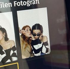 three women are posing for the camera in front of a sign that says fotografit