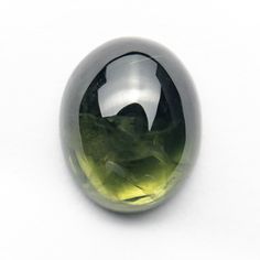 an oval shaped green and black stone