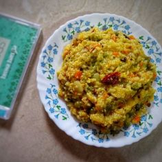 a white plate topped with food next to a book