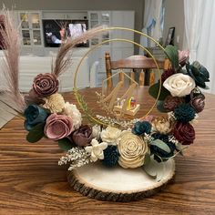 an arrangement of flowers and feathers on a table