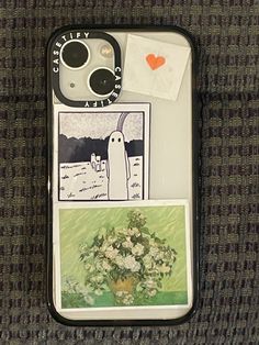 an iphone case with pictures and stickers on the back is sitting on a couch