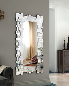 a mirror that is on the wall near a couch