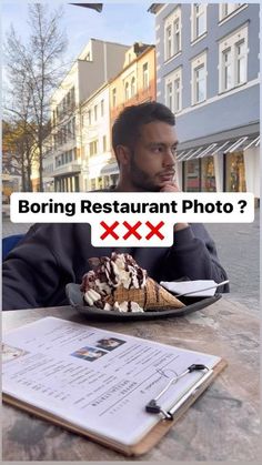 a man sitting at a table with an ice cream sundae in front of him