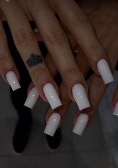 two hands with white nail polish on them