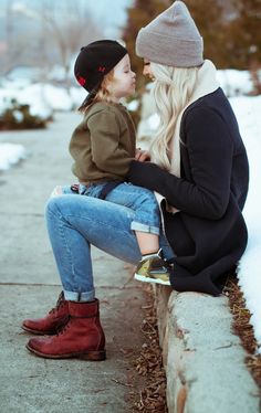 a mother and child sitting on a bench with the caption, something i'm not sure about