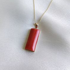 This stunning pendant is set in 14K Solid Yellow Gold with Natural Coral with utmost precision. It is an unique gemstone pendant for nearly every occasion and is completely hassle-free jewelry. ITEM DETAILS * Gem: Coral * Gem Size: 10X24mm * Gem Shape: Rectangle * Gem Weight: 18.75 carats * Gold Purity: 14KT  * Gold Weight: 0.72 gram * Total Weight of the Pendant: 4.47 gram The Gold purity is guaranteed and it comes with authentic 14KT gold hallmark. Since my items are handmade, they are absolutely nickel and lead free. CUSTOMIZATION * Gemstone customization is available and it can be substituted with a gem of your choice. Kindly message me for the same. PACKAGING * The Pendant comes with layers of safe and secure wrapping along with Free handmade jewelry box with every purchase. ➡️Head to Fine Jewelry Rectangular Pendant As Gift, Elegant Jewelry With Bezel Setting Rectangular Pendant, Gift Necklace With Polished Finish And Rectangular Pendant, Luxury Necklace With Rectangular Stone For Gift, Elegant Red Necklace With Rectangular Pendant, Luxury Rectangular Stone Necklace For Gift, Red Rectangular 14k Gold Jewelry, Red Pendant Jewelry With Bezel Setting, Rectangular Red 14k Gold Jewelry