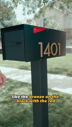 a mailbox with the words, i like the bronze on the black with the red