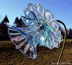 a glass flower is sitting in the grass