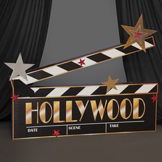 a hollywood sign with stars on it in front of curtains