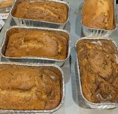 six pans filled with baked goods sitting on top of a counter next to each other