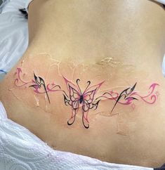 a woman with a butterfly tattoo on her stomach and the bottom part of her lower back