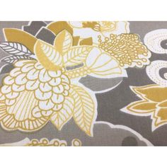 an area rug with yellow and gray flowers on it