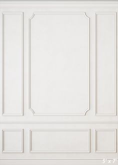 an empty room with white walls and paneling