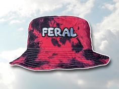 A hand dyed bucket hat with "FERAL" embroidered on it. Made by me! Hat size is 22 inches in circumference. All sales final! DM for any questions or custom requests :) feral hat feral shirt embroidered feral shirt rave gift FERAL feral bucket hat im on a sidequest hat brb im on a sidequest rave outfit festival outfit music festival hat bucket hat tie dye rave gift Rave accessories Rave gift Excision Merch Tie dye bucket hat festival gift festival accessories Rave apparel Rave hat Festival merch Excision Merch Tie dye bucket hat bucket hats rave hats festival hats Cheap Music Festival Cap, Rave Hat, Music Festival Outfits Rave, Funny Bucket Hats, Festival Merch, Rave Hats, Festival Hats, Rave Outfits Festivals, Outfit Rave