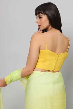 A true Yellow strappy blouse - where it with a matching saree or skirt or as a contrast piece! Product Features: Color: Yellow Fabric: Raw Silk with cotton lining Design - Spaghetti Straps with Pentagon Neckline Not padded Closure: Back Sizing: Not stretchable - margin of 2 inches inside seams for adjustments Occasion: Party, Wedding, Bridesmaid, Festive Product Type: Blouse Disclaimer: There will be slight difference in digital to actual image Bollywood Style Padded Blouse For Summer, Yellow Saree For Summer Party, Festive Padded Blouse Set For Summer, Fitted Yellow Choli For Summer, Fitted Padded Blouse Sets For Summer, Fitted Summer Sets With Padded Blouse, Summer Party Yellow Saree, Festive Summer Sets With Padded Blouse, Fitted Summer Set With Padded Blouse