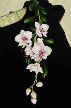 a black shirt with white orchids on it