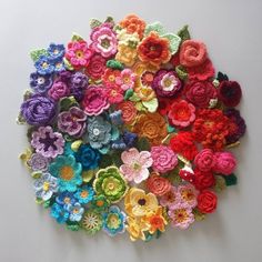 there are many crocheted flowers on the wall