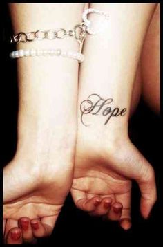 two people with their hands in the air and one has a hope tattoo on it