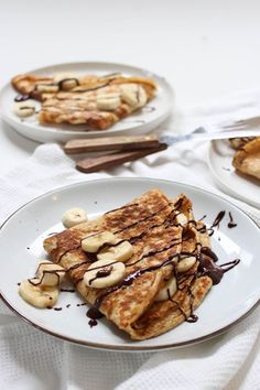 pancakes with bananas and chocolate drizzled on them