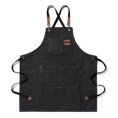 a black apron with two brown straps on the front and one has an orange button