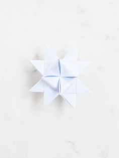 an origami star on a white surface