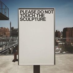 a sign that says please don't touch the sculpture