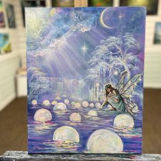 a painting of a fairy sitting on the water