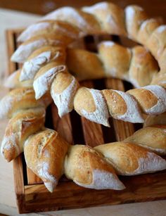 several loaves of bread on a wooden tray